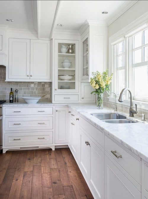 All white kitchen+wood floor